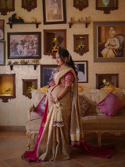 The mother-to-be standing in a beautifully decorated room, her floral accessories adding to the elegance.