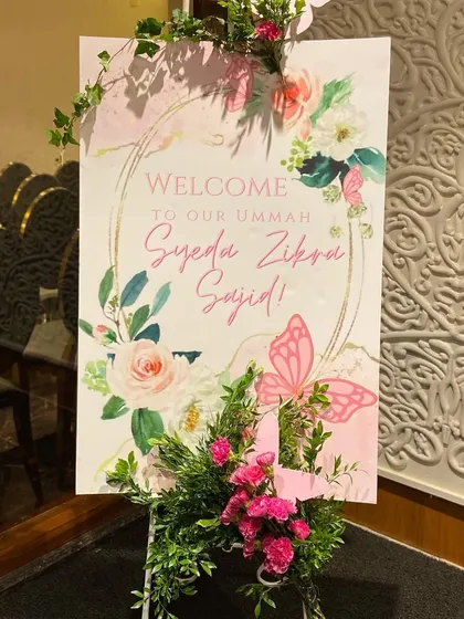 A dreamy butterfly-themed welcome sign for baby Zikra's Aqeeqah. We adorned the sign with fresh flowers and 3D butterflies to create a beautiful entrance piece.
