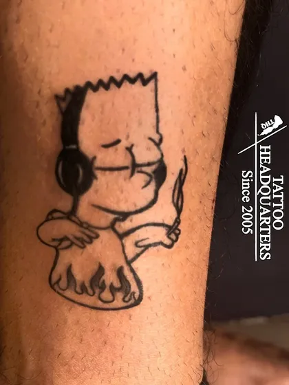 A fun tattoo of Bart Simpson with headphones, showing our ability to create cool cartoon and pop culture designs.