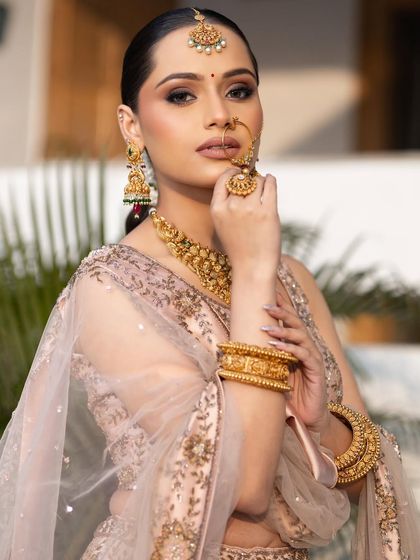 A powerful and poised bridal portrait. Her makeup is flawless, her jewelry is stunning, and her expression is full of confidence.