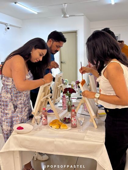 A group of friends and couples enjoying a relaxed evening of painting and sipping at our studio.