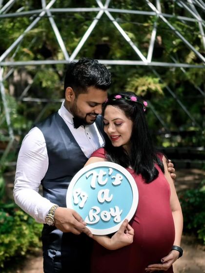 It's a boy! This couple used their outdoor maternity shoot to make a sweet gender reveal. She wears my fitted maroon mermaid gown, which beautifully highlights her bump, paired with his dapper vest and bow tie.