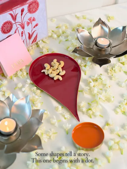 Some shapes tell a story. This one begins with a dot. This image beautifully captures the Bindu plate in use, holding cashews, surrounded by fresh mogra and lotus diyas, creating a serene and festive atmosphere.