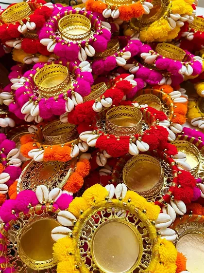 Just look at this burst of color! These are our new pompom and cowrie shell tea light holders, perfect for adding a festive glow to your home during Diwali, weddings, or any celebration. Each one is handcrafted with so much love.