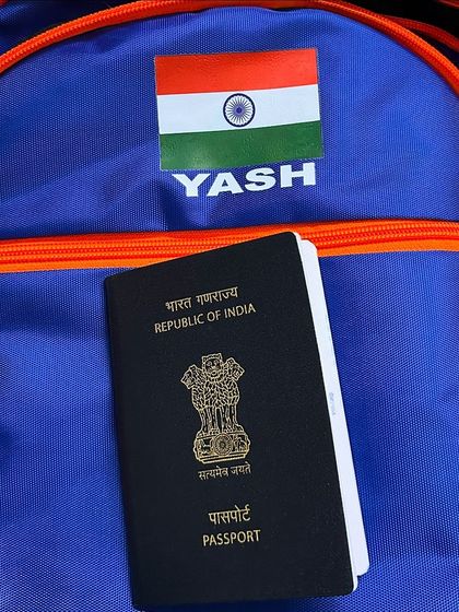 My travel essentials for national duty. The Indian passport and my personalized 'YASH' team bag symbolize my commitment to representing the country wherever my work takes me.