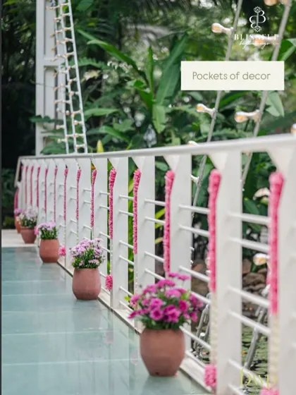 Pockets of decor, like these small potted plants and pink floral garlands, add charm and detail to every corner of the venue. We believe every part of the space should feel special.