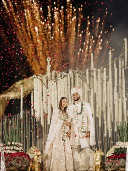 A breathtaking moment as fireworks explode behind the couple on their wedding stage. This is the kind of grand, cinematic shot that creates a truly unforgettable memory.