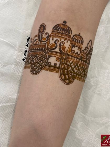 A design featuring peacocks and elephants integrated into a continuous palace facade, creating a sense of royal grandeur.