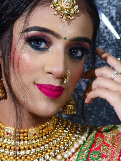 A close-up portrait showcasing the bold pink eye makeup and matching lip color.