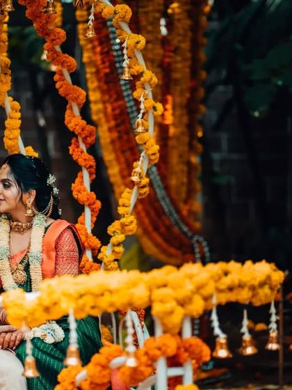 A quiet, romantic moment between the couple on a swing decorated with marigolds, captured during their wedding festivities.