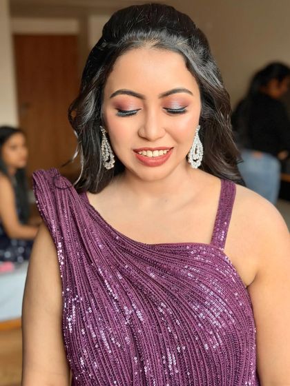 The eye makeup is the star of this look, with its beautiful blend of colors that make her eyes pop.