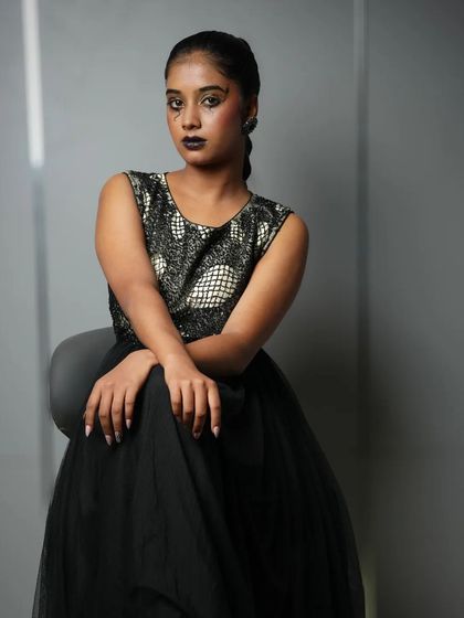 A dark, dramatic, and edgy look from a student portfolio shoot, showcasing versatility beyond traditional bridal makeup.