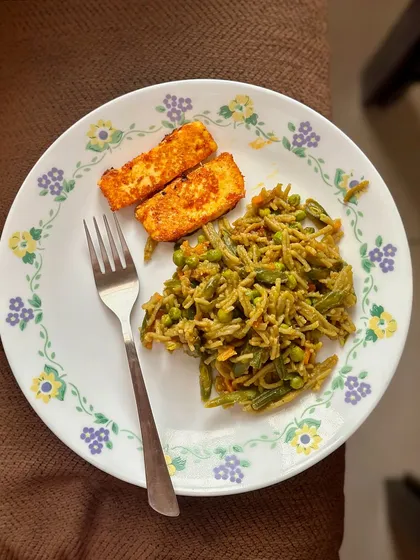 An unconventional but balanced meal of vegetable spaghetti with a side of pan-fried paneer. This shows how you can add a protein source to make any meal more complete and satisfying.