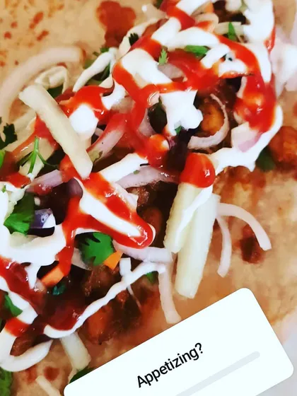 This is the delicious filling for our Chickpea Masala roll. It's a tangy and spicy mix, generously topped with chutneys and sauces before being wrapped up, making it an incredibly appetizing and satisfying snack.