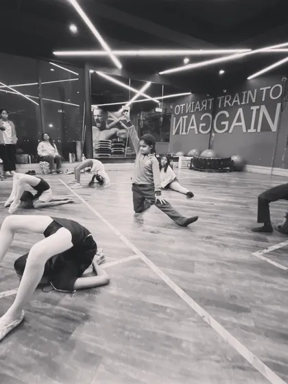 Tiny dancers with big dreams. This black and white shot captures a moment of flexibility training with our youngest students, showing their grace and dedication from a young age.