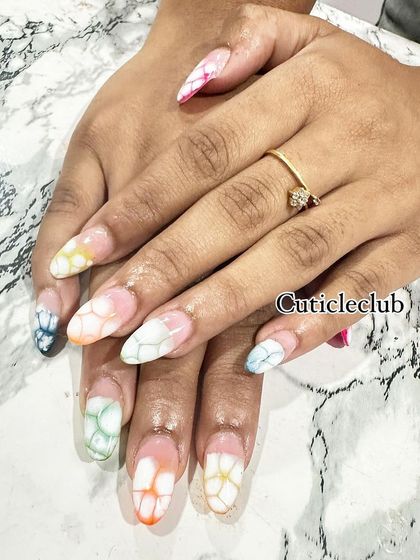 A beautiful watercolor or "blooming gel" effect. I created this multi-colored flower petal design on each nail for a soft and artistic look.
