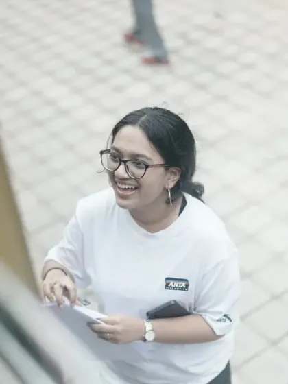 A smiling team member at the registration desk, welcoming everyone to the event.