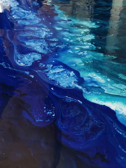 This is a close-up of the first layer of an abstract seascape. I use fluid art techniques to create the organic movement of water and waves, playing with different shades of blue.