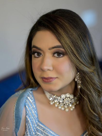 A close-up on the makeup. The brown smoky eye makes her eyes pop, while the skin remains fresh and dewy.