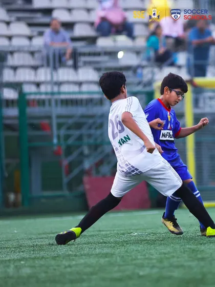 Eyes on the prize. A player focused on winning the ball in a defensive duel.