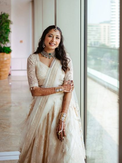 A full length shot of this bride by the window. The natural light shows off the dewy, fresh skin and the soft waves in her hair, creating a very modern and chic bridal portrait.