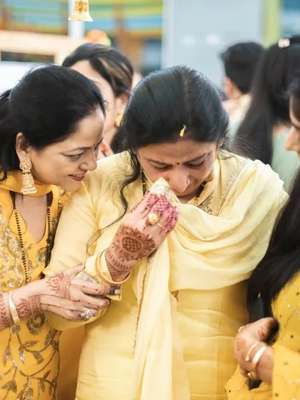An emotional moment as the bride's mother gets teary-eyed during the haldi ceremony.