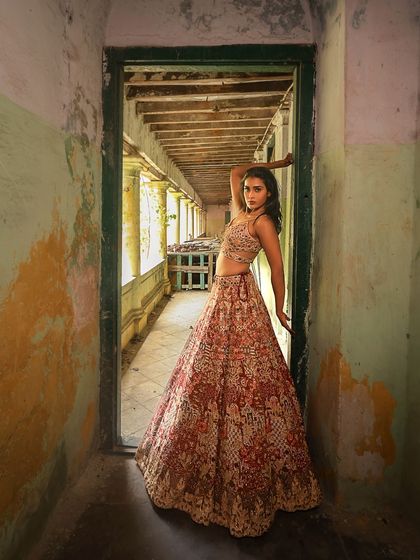 An artistic shot of Poornima Ravi from our photoshoot. The dramatic lighting and her powerful pose highlight the versatility of the makeup and hair, suitable for editorial work.