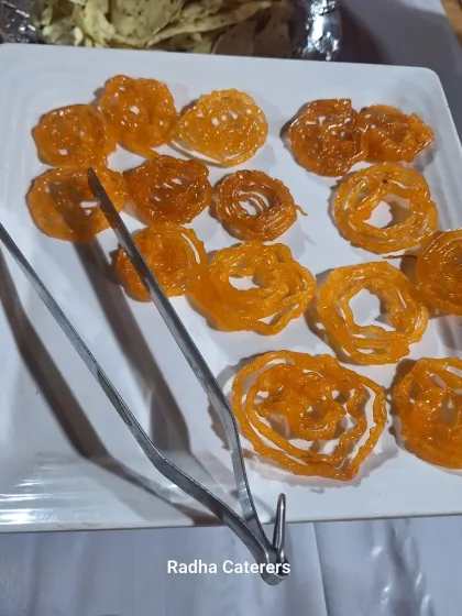 Hot, crispy Jalebis served at a society function. This classic Indian sweet is always a delightful surprise for guests.