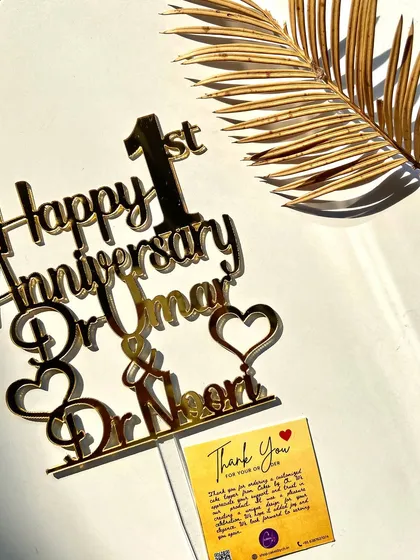 A styled shot of the "Happy 1st Anniversary" topper, showcasing its elegance and quality.