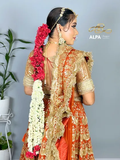 A three-quarter view showing the beautiful fall of the dupatta and the intricate hairstyle.