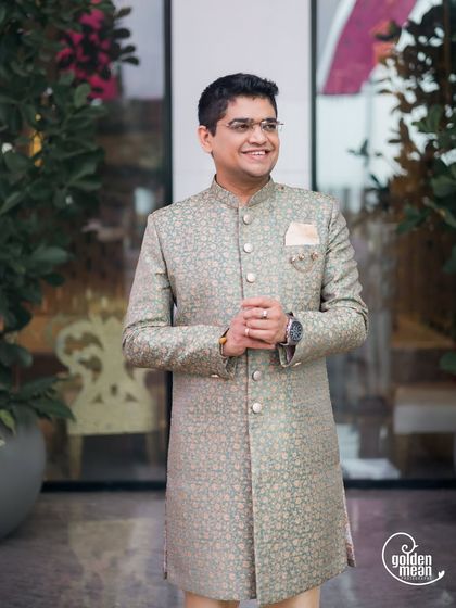 A classic portrait of the groom looking dapper in a patterned sherwani. A great example of a modern ethnic look for an engagement event.