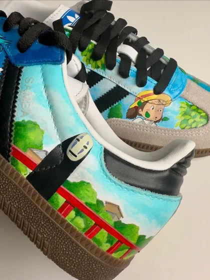 A close-up on the heel of the Ghibli Sambas, showing No-Face from Spirited Away on the iconic red bridge. It's all about capturing those memorable moments.