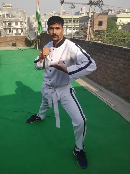 My student Shrikant Hudda, a Green Belt, in a ready stance on a rooftop. We train anywhere, anytime. The city is our dojo.