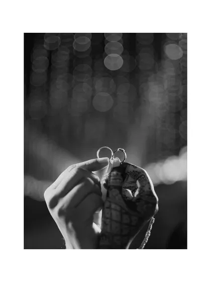 A creative black and white shot focusing on the engagement rings. I believe in capturing the details that symbolize your commitment, turning them into a piece of art.