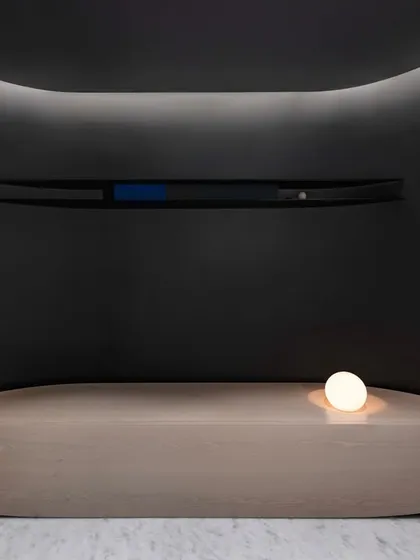 In the entrance foyer of our 'A Hint of Azul' project, we designed this doubly curved bench to fit perfectly within a unique alcove. The piece is not just seating; it is a sculptural form that guides movement and complements the curved nature of the architecture.