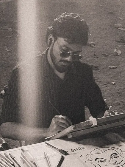A black and white photo of me sketching, capturing the focus and passion I have for my art.