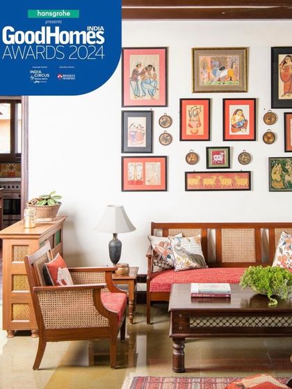I believe a home should be a gallery of personal stories. In this seating area, a collection of traditional Indian art is displayed above a classic cane and wood sofa, creating a corner that is rich with culture and memory.