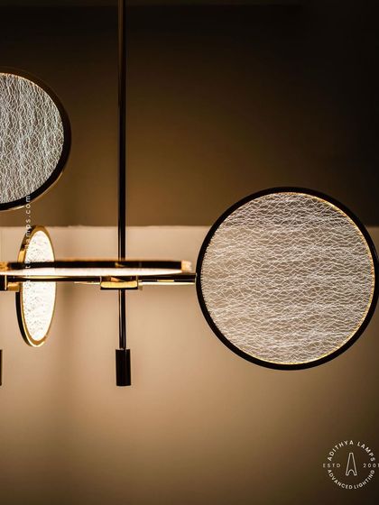 This artistic chandelier is composed of multiple circular discs with a unique woven texture. The layered arrangement and soft backlighting create a beautiful interplay of light and shadow, making it a captivating centerpiece.