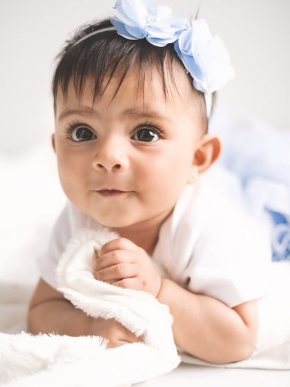 Those big, curious eyes say it all. This close-up from a sitter session captures the wonder and innocence of this special age, where every day brings a new discovery.