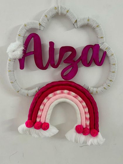 The "Aiza" name hanging in a beautiful magenta color scheme, shown here without the lights. The pom-poms add a fun, playful element.