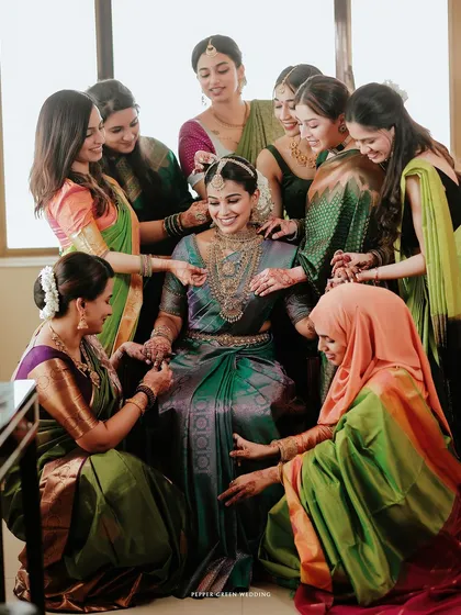 The bride's friends help her get ready, a beautiful moment of friendship and support on her big day.