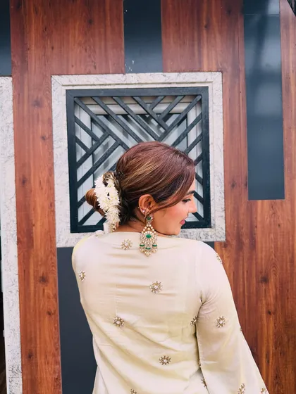 A closer look at the hairstyle for my Rakhi outfit. A simple bun adorned with fresh gajra and paired with heavy emerald earrings adds a touch of classic elegance to the modern silhouette.
