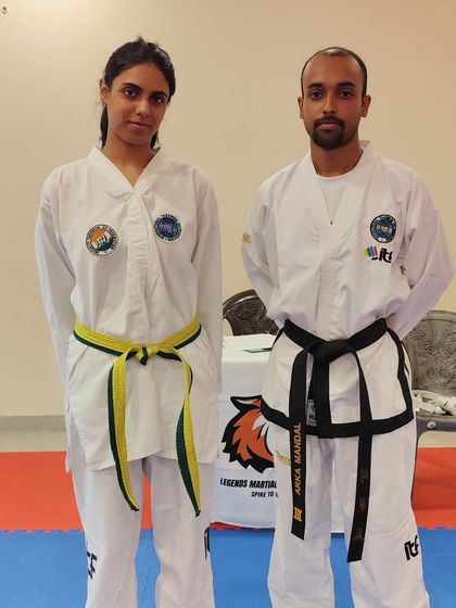 A student and coach stand together after a successful grading, a partnership built on trust and hard work.