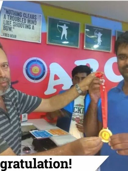 A participant receives his medal from our instructor. This recognition is part of what makes shooting at Stanley Sports a special experience.
