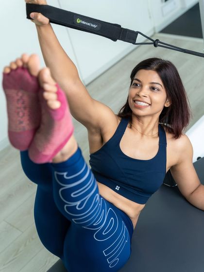 A happy pose to start the new month. This playful stretch on the reformer tower shows the joy and freedom of movement that comes with a consistent Pilates practice.