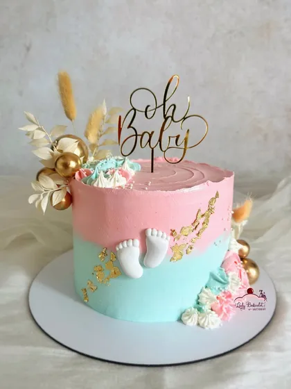 The "Oh Baby" shower cake on its own, with its delicate dried florals and gold leaf accents.