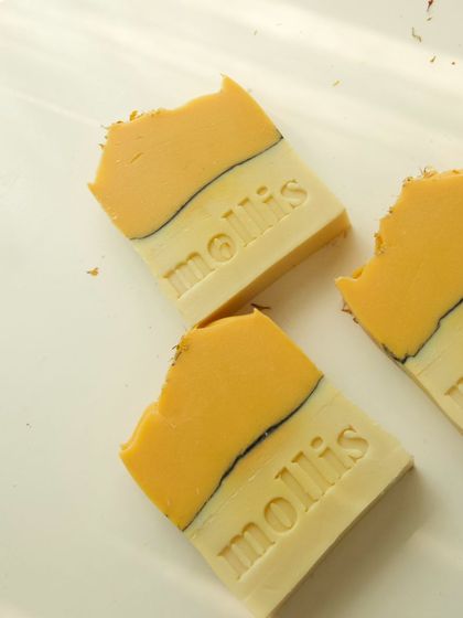 Bright yellow and white soaps with a striking black pencil line.