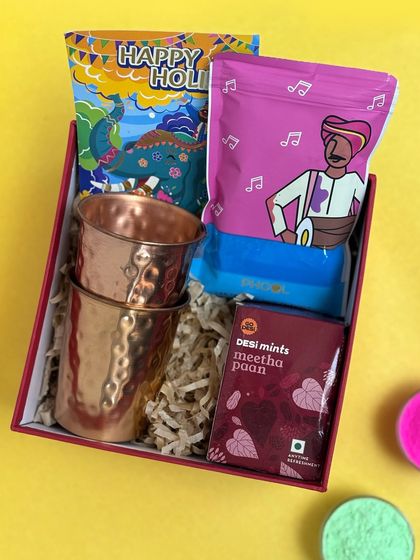 For a more lasting Holi gift, this hamper includes two hammered copper glasses. They are paired with a packet of gulal and desi meetha paan mints for a unique and traditional touch.