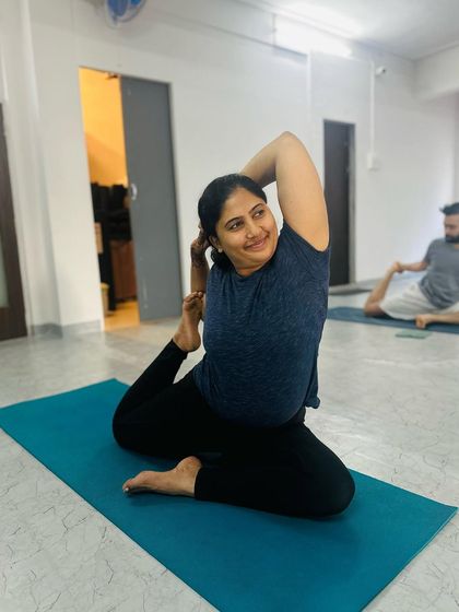 A practitioner demonstrates a serene and focused Mermaid Pose, embodying the calm strength we cultivate in our yoga practice.