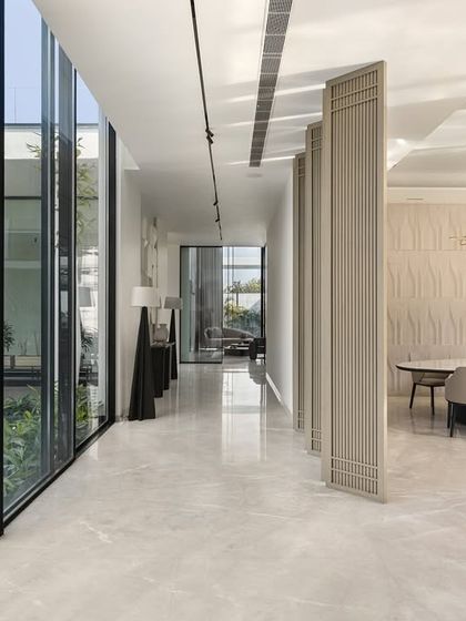 This corridor in our Amritsar residence offers a choice of beautiful views, with the dining area on one side and a courtyard on the other. The design uses pivoting panels to allow for both connection and separation, a quiet balance of form and function.
